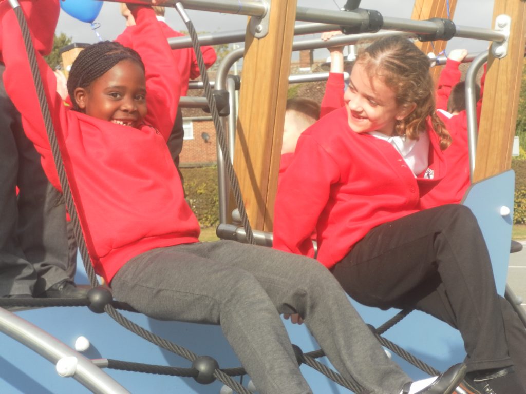 pair of girls playing on Proludic example of school play equipment