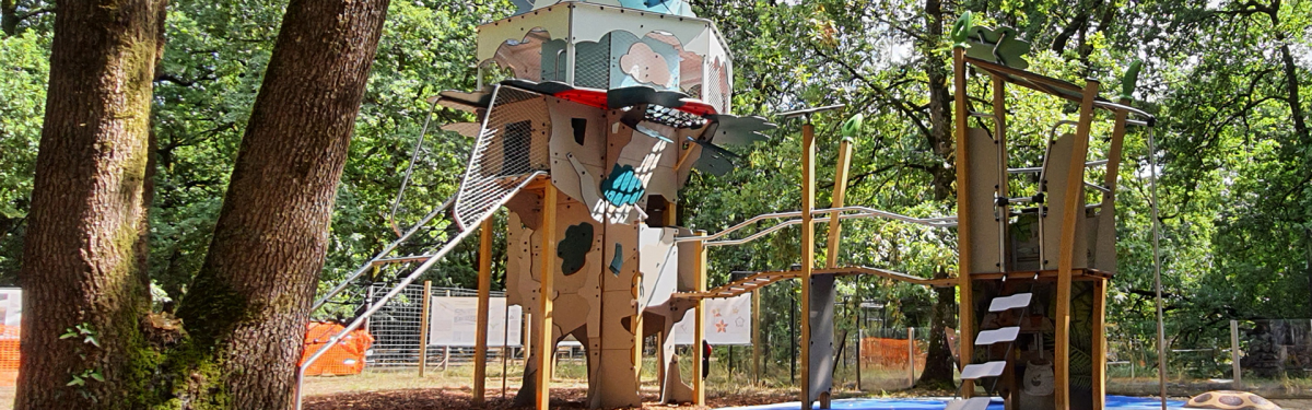 The airship observatory themed play structure at Zoodyssée animal park. A large brown multiplay structure with play tower topped with a white and blue airship design, with various climbing and crawling zones.