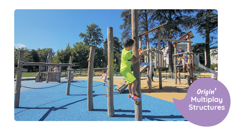 Origin' Multiplay Structure from Proludic UK's sustainable and environmentally friendly playground equipment range. Children are playing on the equipment with a small boy in the foreground climbing a post.
